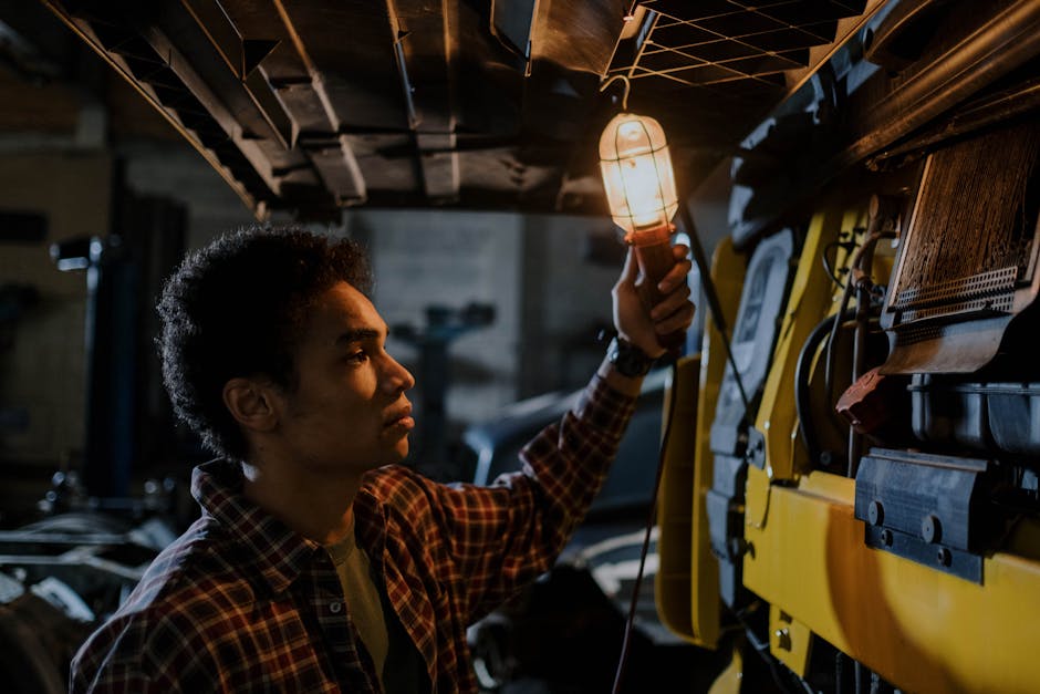 Technician inspecting a furnace system with a diagnostic light